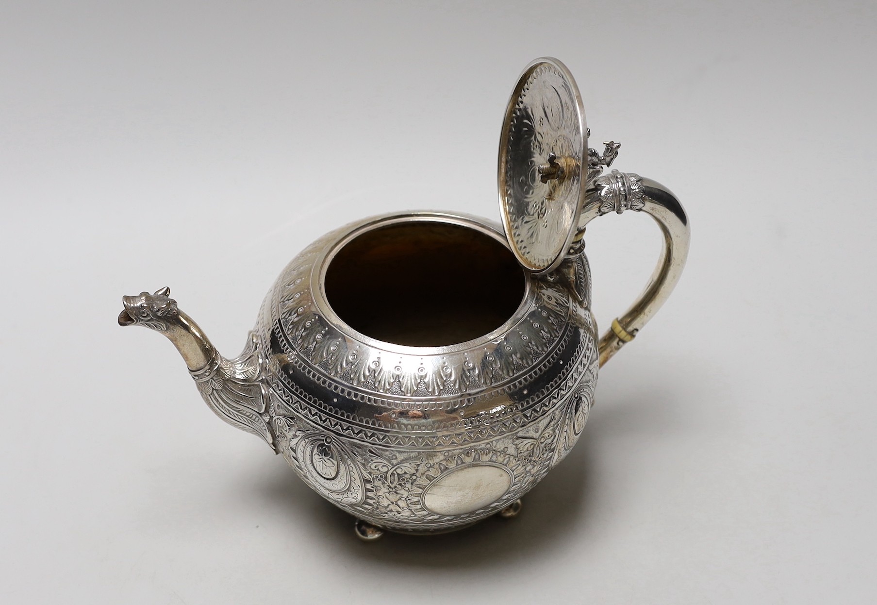 A Victorian embossed silver globular teapot, by William & John Barnard, London, 1893, with dragon finial and mask spout, gross weight 22.1oz.